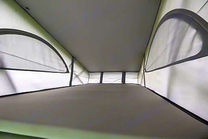 This RV rental's pop-top sleeping area offers mesh windows and a comfortable bed, perfect for camping.. Volkswagen California Ocean 2024