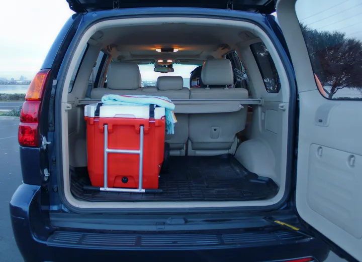 SUV cargo ready for travel. Cooler and blanket packed, perfect for an outdoor trip, similar to an RV rental adventure.. Other Other 2004