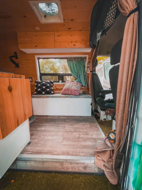 Explore this RV rental's inviting wood-paneled interior. Features a cozy bench, laminate flooring, and ceiling fan.. Mercedes-Benz sprinter 2008