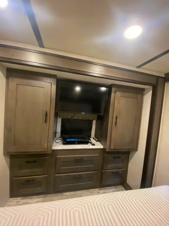 RV rental: Modern interior with built-in TV and ample storage cabinets, offering comfort on the go.. Forest River Other 2021