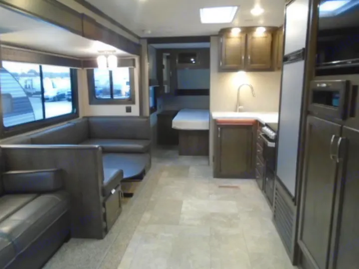 Spacious RV rental interior featuring a full kitchen, comfortable living area, and a glimpse of the bedroom.. Jayco Jay Flight 2020
