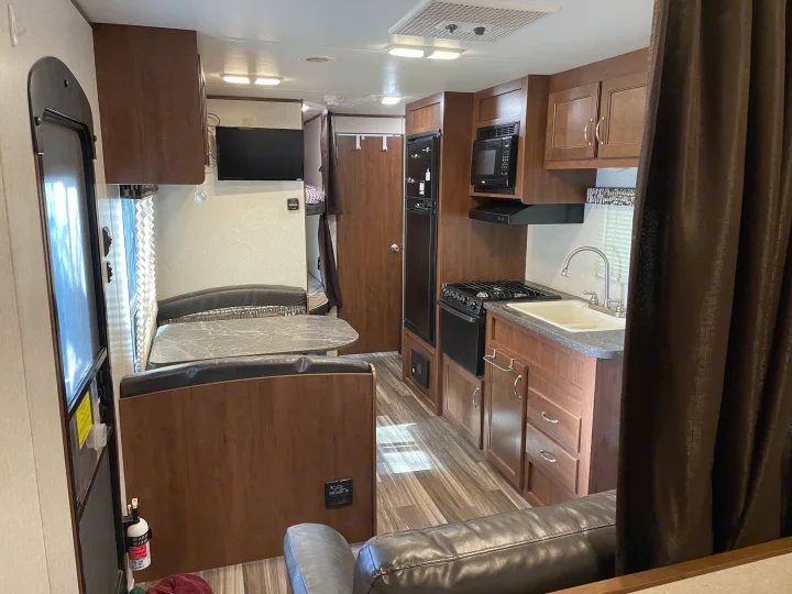 RV rental: Bright interior with kitchen (stove, sink, microwave), dining booth, sofa, and bunks. Ideal for travel.. Jayco Jay Flight SLX 2017