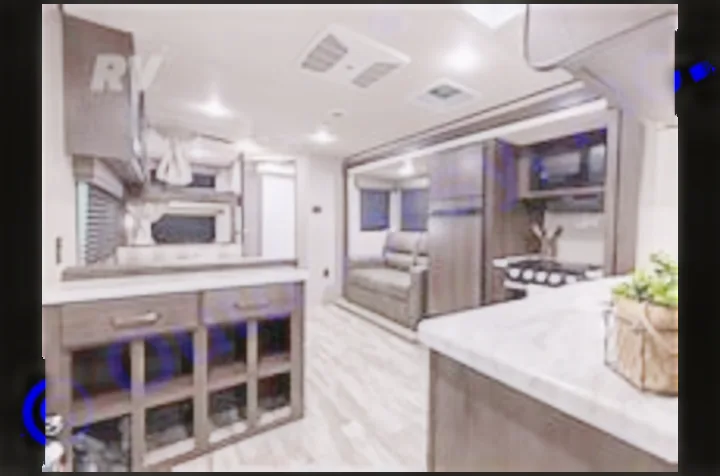 Experience comfort in this modern RV rental interior! Spacious travel trailer living area with full kitchen, sofa, and dining bar.. Grand Design Transcend Xplor 2022