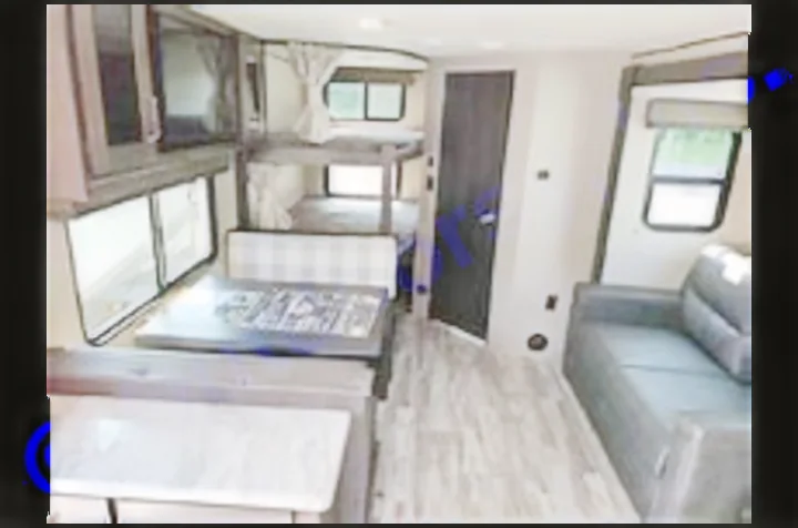 Spacious RV rental interior: A modern mobile home with dinette, bunk beds, sofa, and kitchen counter for family trips.. Grand Design Transcend Xplor 2022