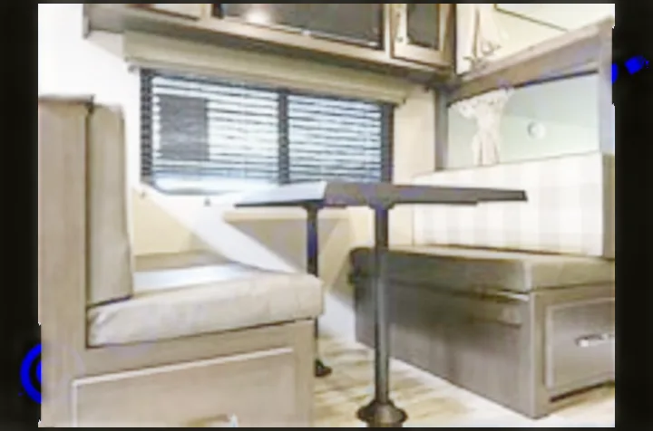 Modern RV rental dinette: a cozy interior with upholstered benches, table, and a window with blinds. Ideal for your next trip.. Grand Design Transcend Xplor 2022