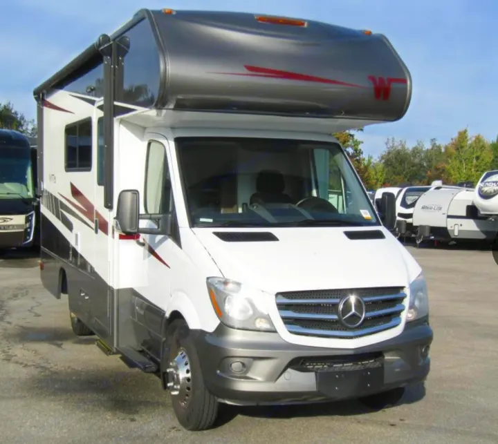 White Mercedes-Benz Sprinter Class C RV, featuring a dark gray over-cab with a red 'W' logo. Perfect for rv rental.. Winnebago Vita 2019