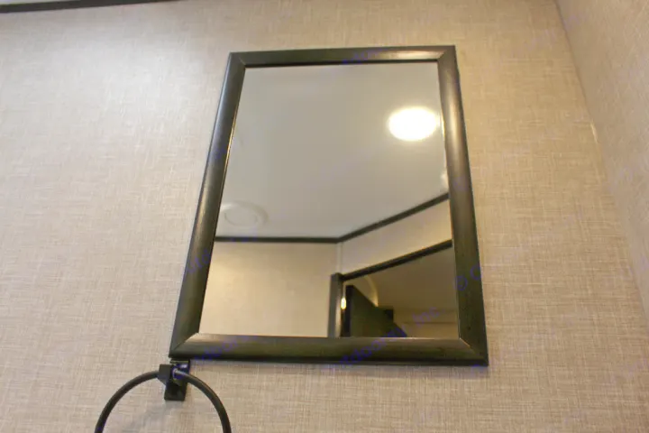 RV rental: Wall-mounted mirror with a towel ring, reflecting an interior light and room elements.. Jayco Jay Flight SLX 224BH 2022