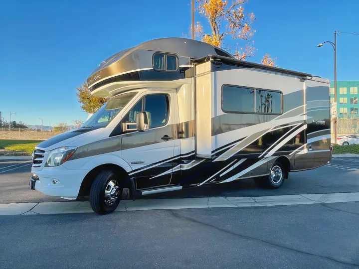 Modern Winnebago Navion RV rental, featuring striking graphics, ready for your next travel adventure.. Itasca Navion 2016