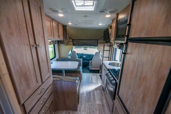 Explore this modern rv rental interior, featuring a full kitchen, dinette, and comfortable front cabin.. Forester LE 2018