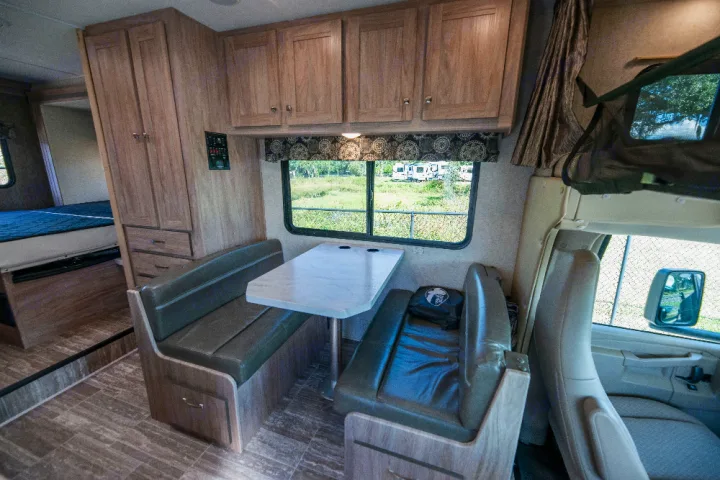 This RV rental interior offers a dinette, sleeping area, and storage, showcasing a comfy setup for travel adventures.. Forester LE 2018