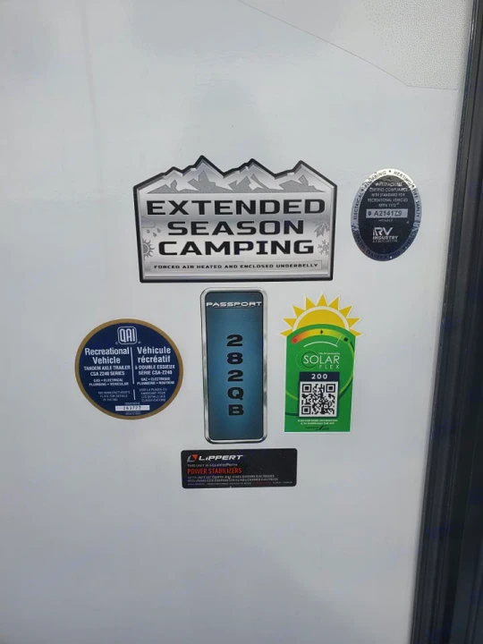 Side of a Passport 282QB RV rental detailing Extended Season, Solar Flex, power stabilizers, and safety specs.. Keystone RV Passport SL 2022