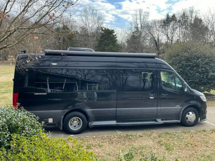 Stylish black "WEEKENDER" camper van for rv rental, parked on a driveway. Perfect for travel.. Midwest Automotive Designs Midwest Automotive Designs Class B 2020