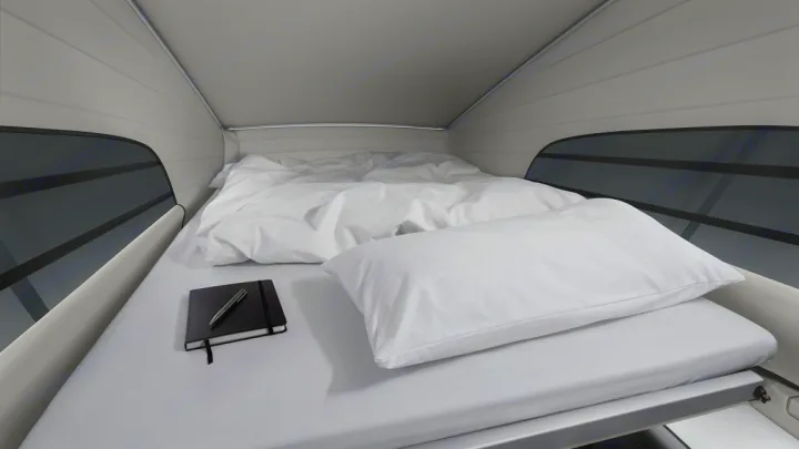 Spacious bed with white linens, pillow, and notebook in a modern RV rental. Enjoy comfortable sleeping on your travels.. Mercedes Marco Polo 2022