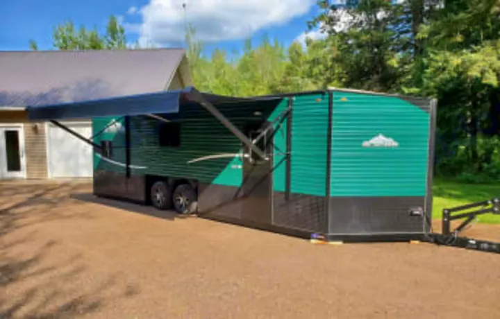 This modern green and black ice house RV, perfect for an RV rental adventure, features an extended awning.. Glacier Ice House Glacier Ice House Trailer 2019