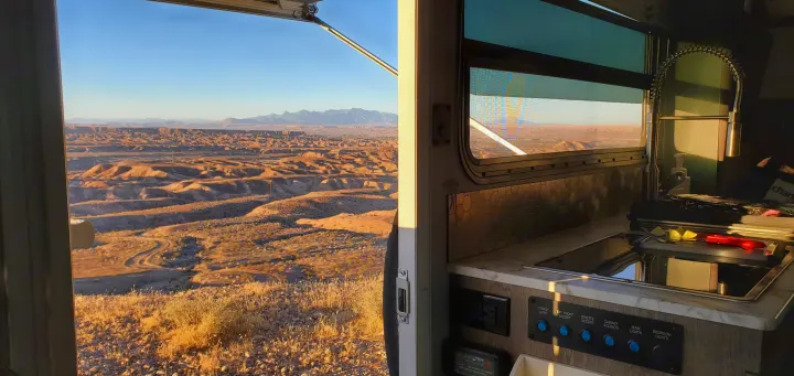 Breathtaking desert views from your RV rental's kitchen. Enjoy scenic travel with a cozy camper interior.. InTech RV Sol Horizon 2020