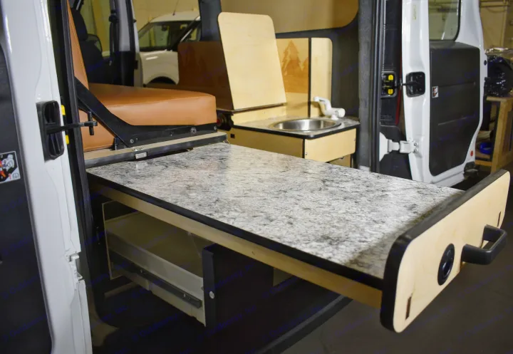RV rental's versatile interior features a pull-out counter, compact sink, and comfortable seating.. Dodge Promaster City 2021