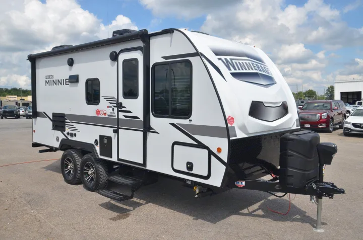 This white Winnebago Micro Minnie travel trailer, a compact recreational vehicle, is perfect for RV rental adventures.. Winnebago Micro Minnie 1800BH 2022