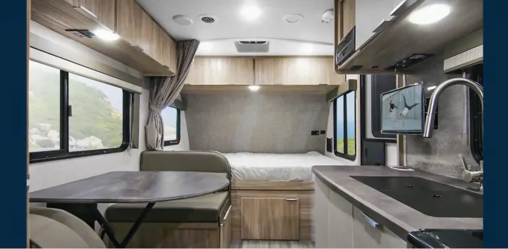Explore this modern RV rental interior: cozy bedroom, dinette, kitchen with sink, and entertainment TV.. Winnebago Micro Minnie 1800BH 2022