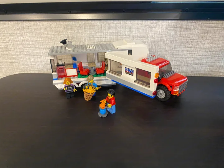 Lego RV rental playset with minifigures enjoying camping, fishing, and grilling. A fun outdoor adventure scene.. Keystone RV Bullet Ultra Lite 2021