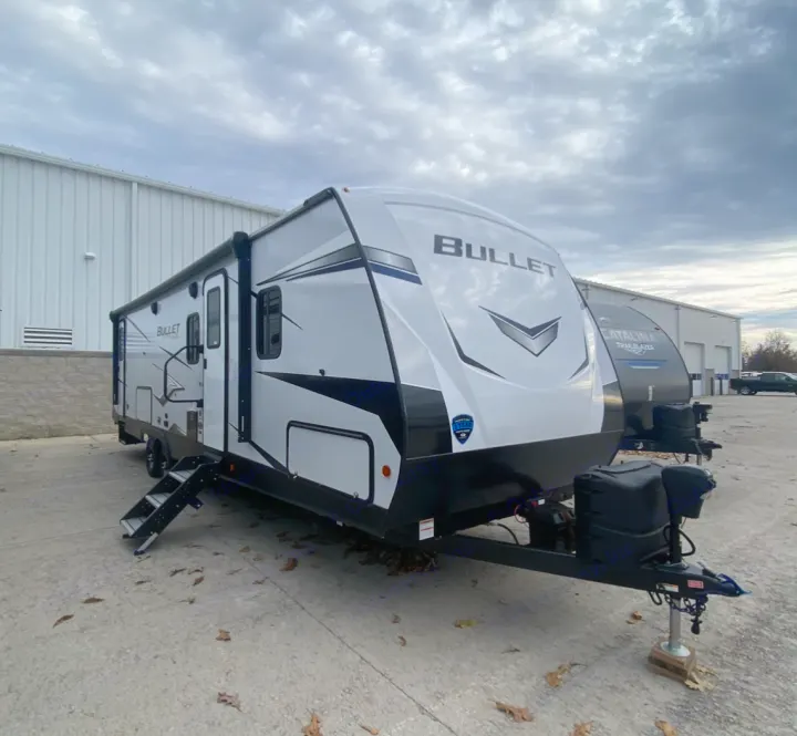 Sleek white Bullet travel trailer for RV rental, ready for your next outdoor adventure.. Keystone RV Bullet Ultra Lite 2021