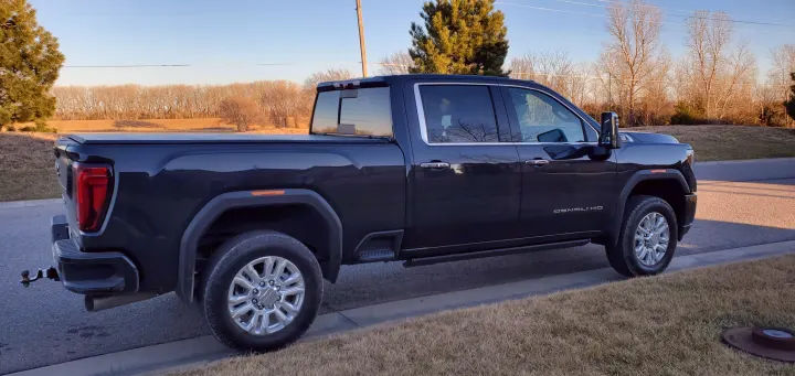 Full side view of a dark gray GMC Denali HD pickup truck, perfect for heavy towing like an RV rental adventure.. GMC Sierra 2500HD Denali 2020
