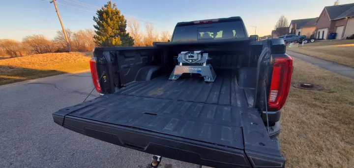 Rear of pickup truck showing a B&W Companion 5th wheel hitch in the bed, great for RV rental towing.. GMC Sierra 2500HD Denali 2020