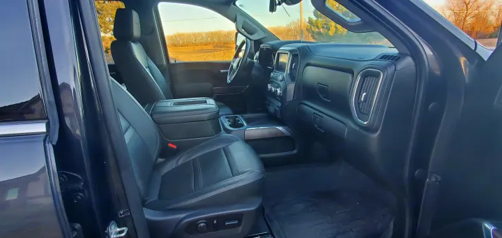 Detailed view: modern truck's black leather interior, dashboard, steering wheel, front seats. Great for RV rental trips or road travel.. GMC Sierra 2500HD Denali 2020