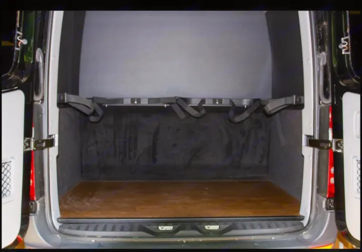 RV rental van's rear cargo area: wooden floor, lined walls, and adjustable straps for secure transport.. Mercedes-Benz Sprinter 2500 2016