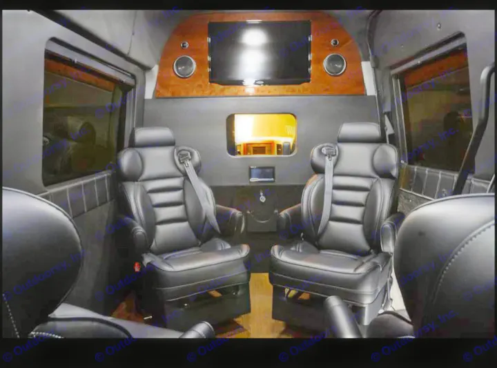 Premium RV rental interior featuring two plush black leather captain's chairs, a large TV, and custom wood details.. Mercedes-Benz Sprinter 2500 2016