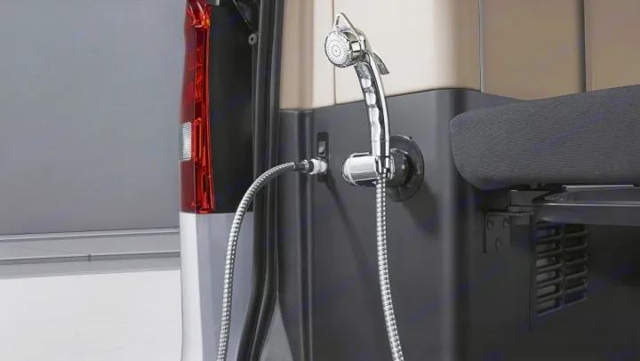 Close-up of an RV rental's rear, showing a mounted chrome outdoor shower unit with a flexible hose.. Mercedes Marco Polo 2022