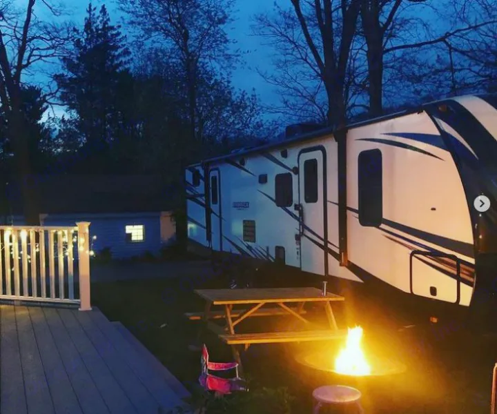 Relaxing evening camping at your RV rental site, complete with a cozy campfire and deck lights. Perfect outdoor getaway.. Cruiser RV Embrace Ultra Lite 2019