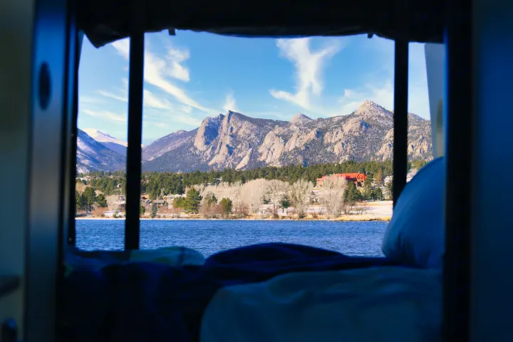Wake up to stunning Rocky Mountain views from your RV rental! Lake and snow-dusted peaks framed by your cozy mobile home.. Winnebago Revel 2022