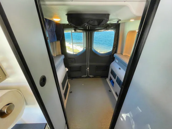 Explore with this RV rental! Inside a camper van, enjoy a water view from the rear windows, with modular interior and storage.. Winnebago Revel 2022