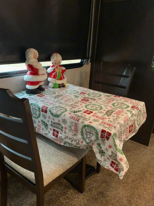 This cozy rv rental features a festive dining area with Santa & Mrs. Claus figurines and a Merry Christmas tablecloth.. Heartland RVs Elkridge 2019