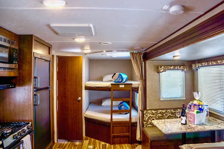 Spacious rv rental interior with kitchen, bunk beds, and dining area, ready for your adventure.. Keystone Hideout 2018