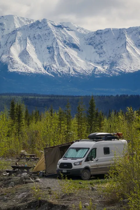 RV rental camper van set up for scenic mountain camping with an awning & picnic tables. Perfect for nature lovers.. Ford Transit Custom 2015