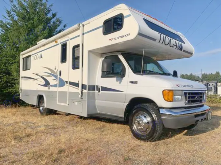 White and gray Fleetwood Tioga Class C RV, parked outdoors. Perfect for your next rv rental, camping, or road trip.. Fleetwood Tioga 2005