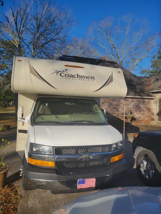 White Coachmen Freelander RV rental, a Class C motorhome, parked outdoors under a blue sky, ready for adventure.. Coachmen Freelander 2017