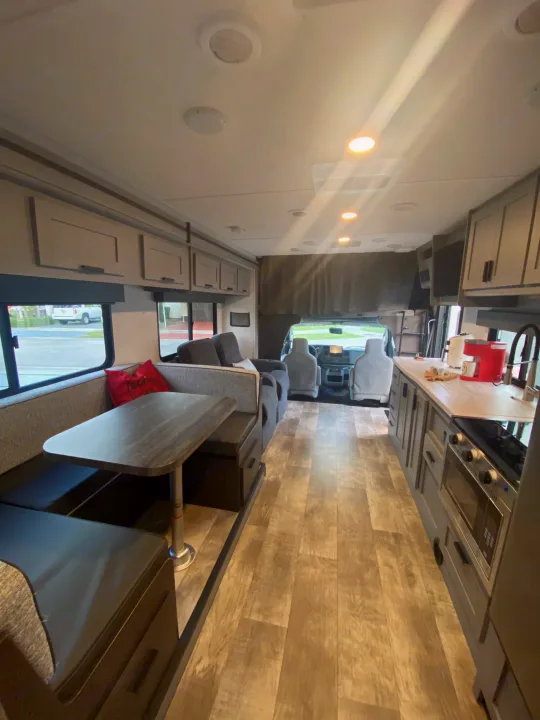 Step inside this cozy RV rental interior, featuring a full kitchen, dinette, and comfortable living space for your adventures.. Forest River Solera 2022