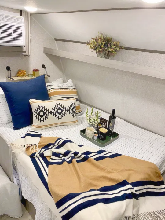 Short queen size bed with added 8” memory foam mattress. AC unit above bed, and a tv on the other wall across from it. Fresh clean linen included.. Coleman Lantern 17B 2022