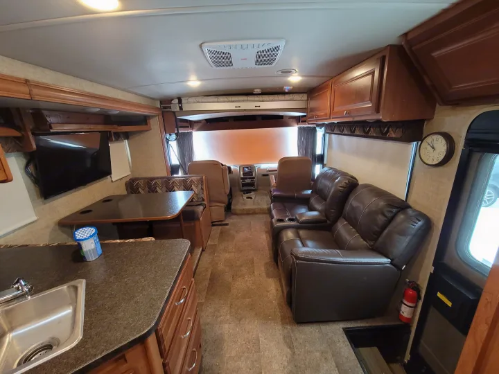 Spacious RV rental interior with living area, kitchen, dinette, and cockpit, perfect for your next adventure.. Winnebago Vista 2018