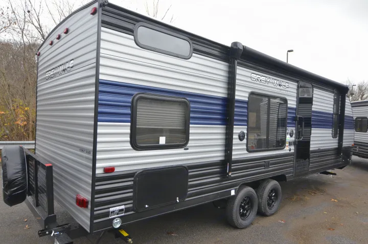 This "Grey Wolf Limited" travel trailer, featuring a grey and blue exterior with a rear cargo rack, is ready for your next RV rental.. Forest River Cherokee 2021