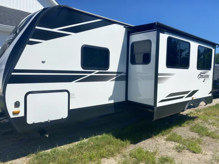 This sleek white RV rental with black trim and a slide-out is ready for your next outdoor adventure.. Grand Design Imagine 2800BH 2019