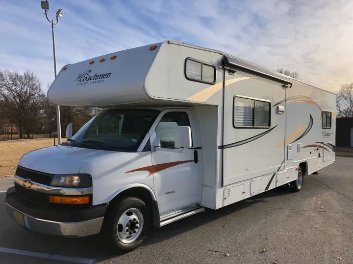 White Coachmen Freelander RV rental parked outdoors, ready for adventure under a partly cloudy sky.. Coachmen Freelander 2014