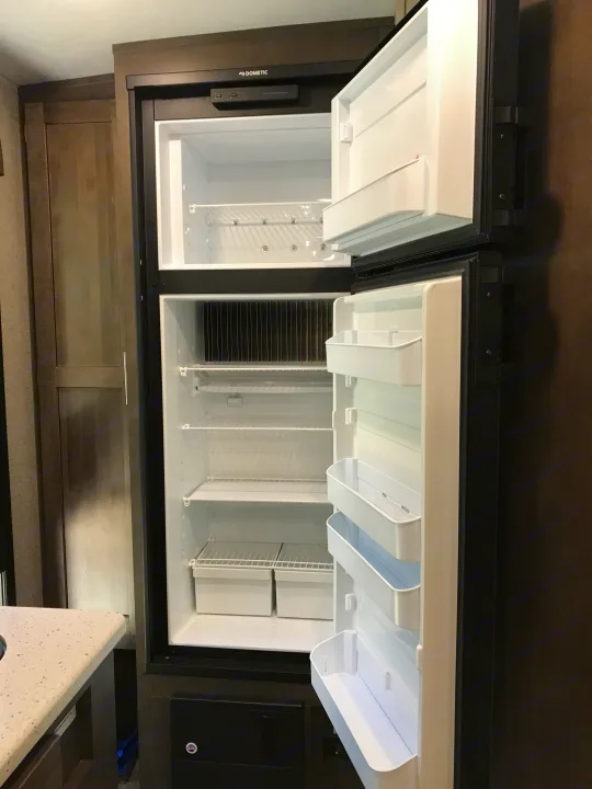 Spacious, empty Dometic RV refrigerator, ideal for your rv rental. Features a top freezer & ample shelving.. Forest River Rockwood Mini Lite 2020