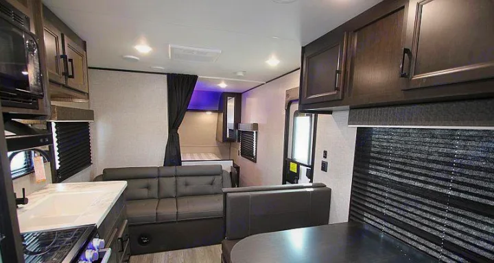 Modern RV rental interior with kitchen, living space, and a private sleeping area.. Jayco Jay Flight 2022