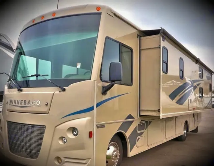 This beige Winnebago motorhome, perfect for rv rental, features an extended side slide-out, ready for adventure.. Winnebago Vista 2018