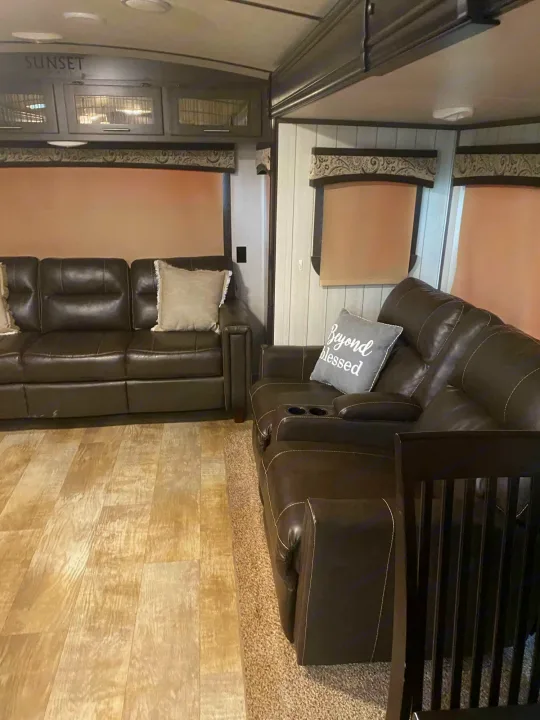 Enjoy this inviting rv rental living space with dual leather sofas, "Sunset" cabinets, and bright window blinds.. Crossroads Sunset Trail Reserve 2018