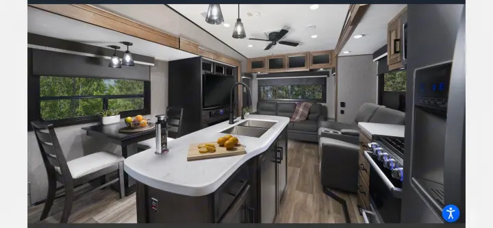 Modern RV rental interior: spacious kitchen, dining area, and living room with TV. Your comfy home on wheels!. Jayco Eagle 2021