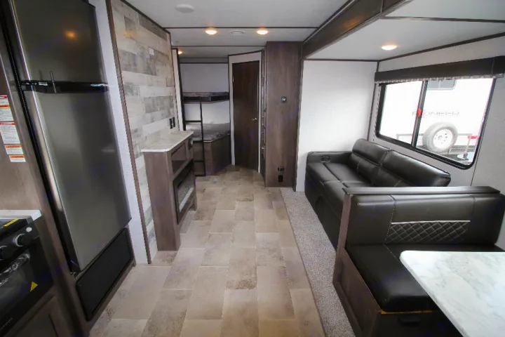 Spacious RV rental interior: modern kitchen, comfortable dinette, sofa, & private bunk room. Ideal for family trips.. Dutchmen Coleman 2022
